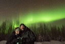 Photo of couple in front of the aurora borealis