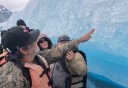 Photo of guest touching iceberg on tour