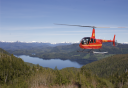 Photo of helicopter flying over mountain lakes
