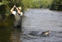Photo of man stream fishing