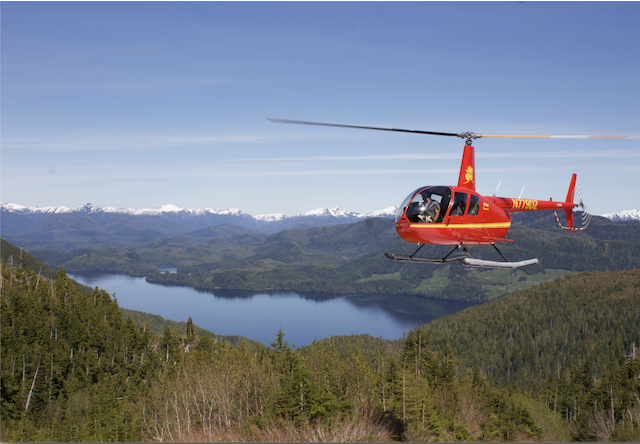 Photo of helicopter flying over mountain lakes